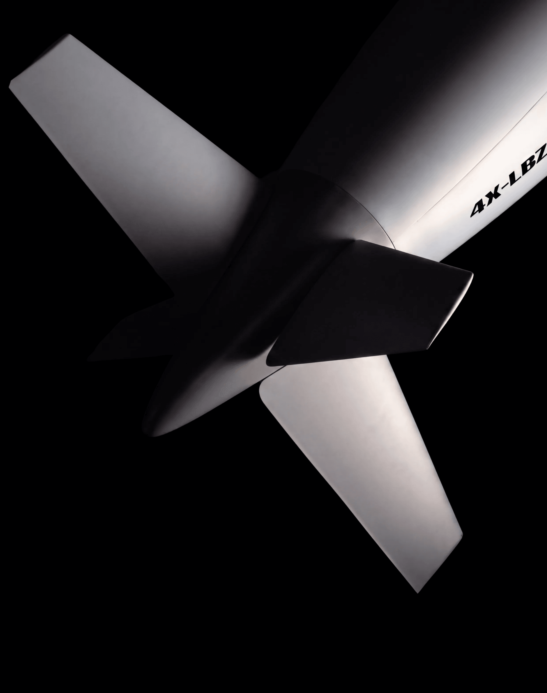 The cruciform tail fins of the Covenant airframe seen from below against black.